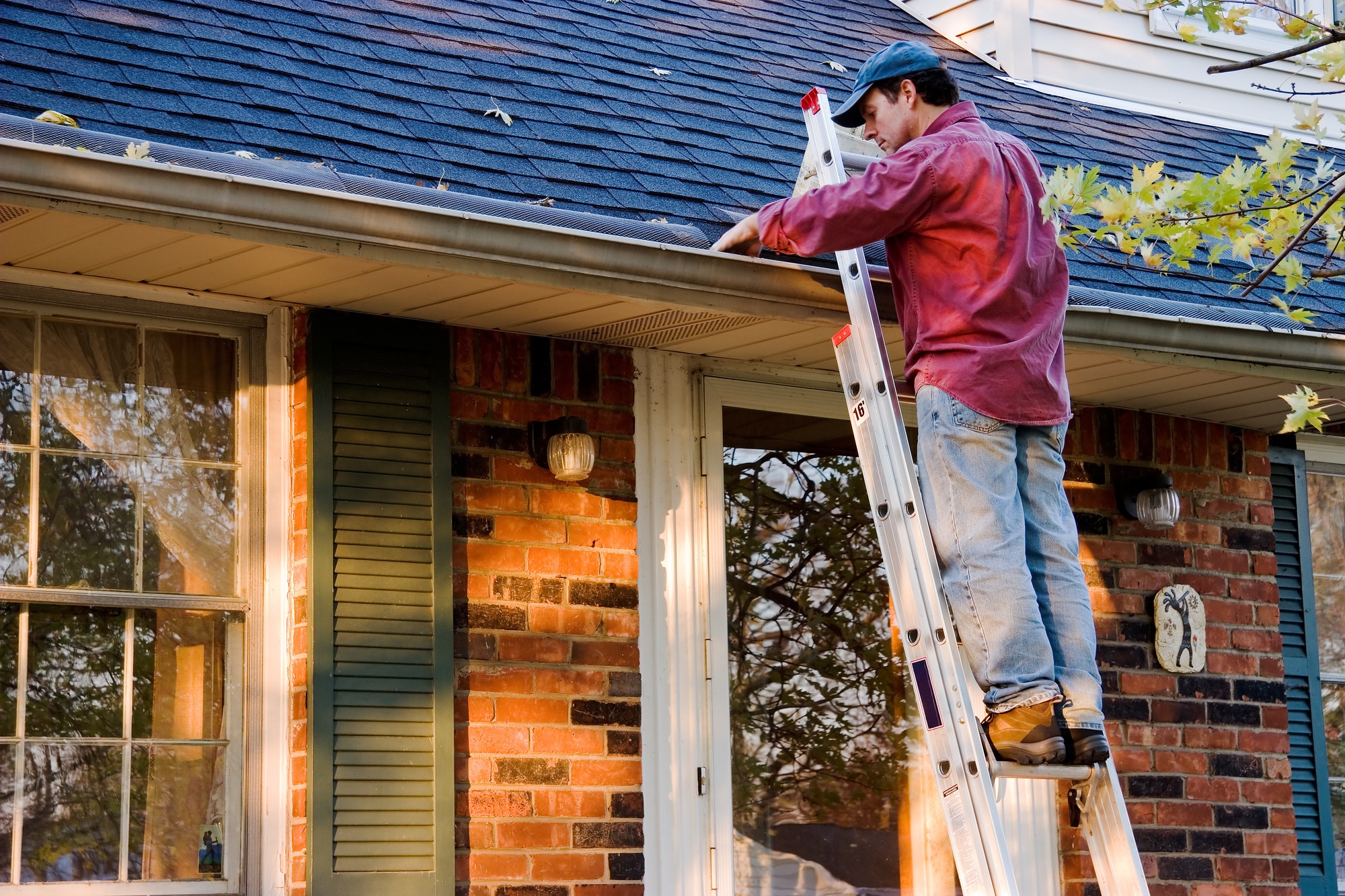 Fall-Checklist-Man-Cleaning-Gutters